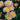 Close-up of pink and yellow flowers with green leaves